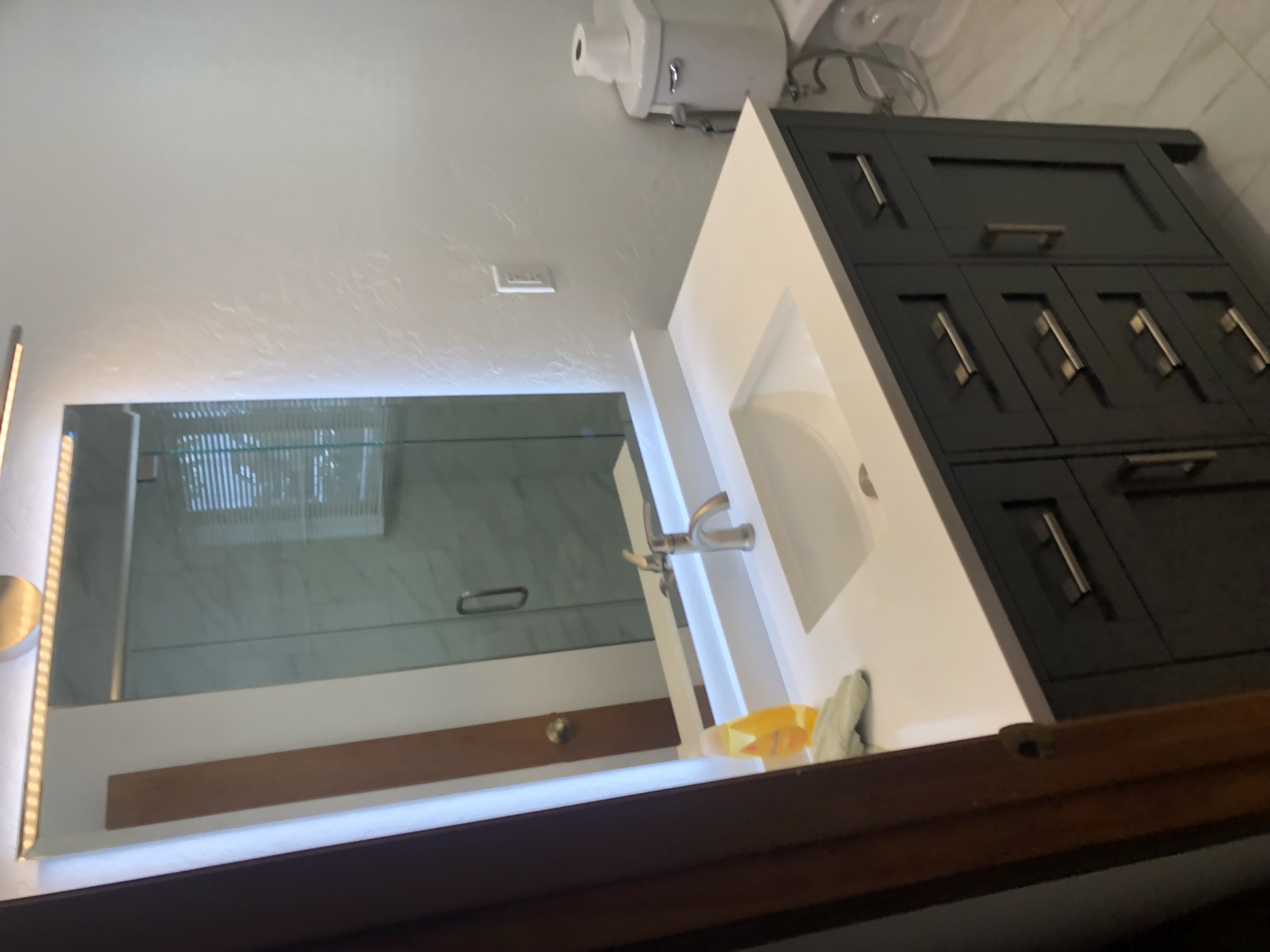 Bathroom vanity with backlit mirror