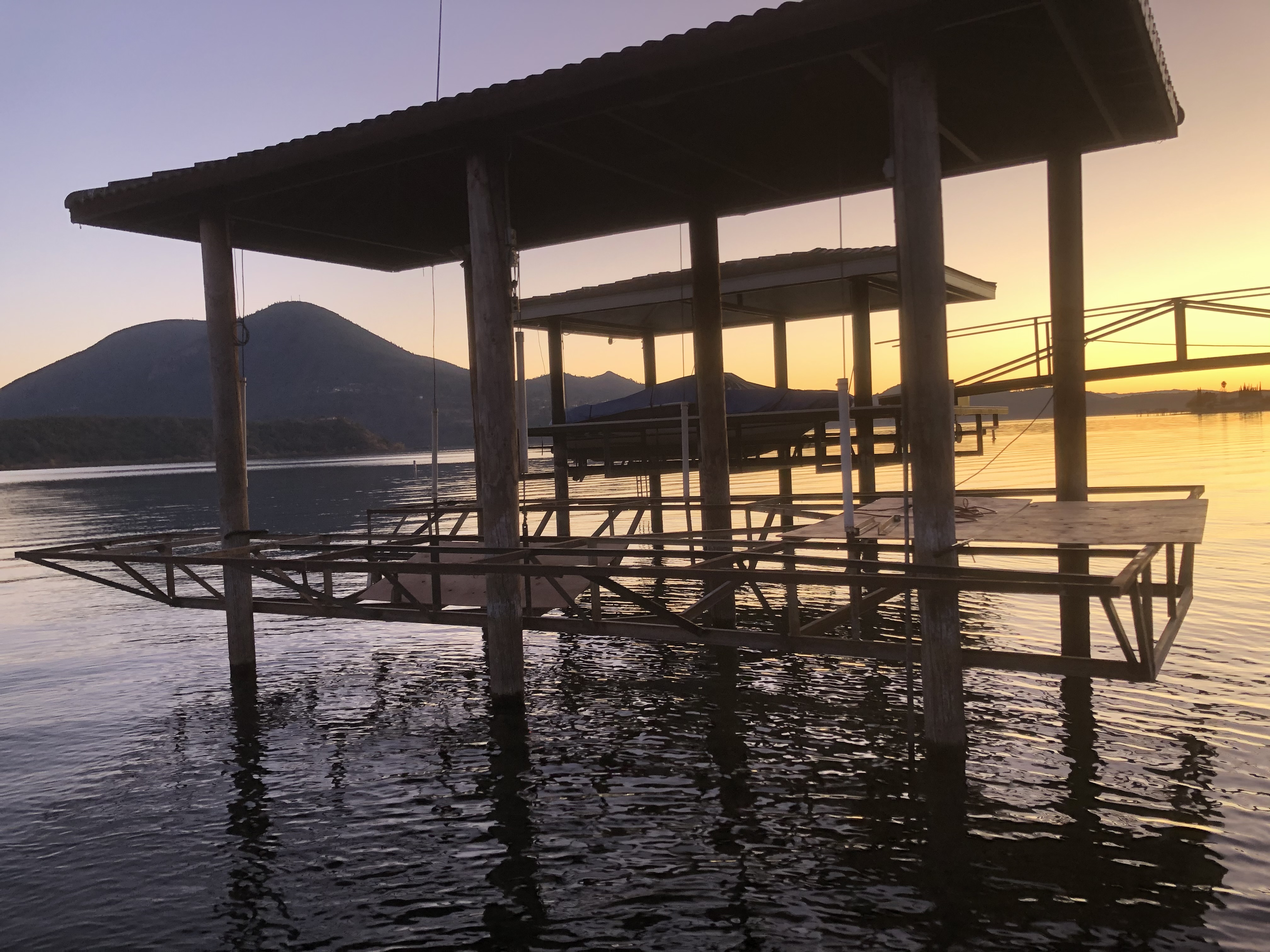 Covered boathouse dock at sunset