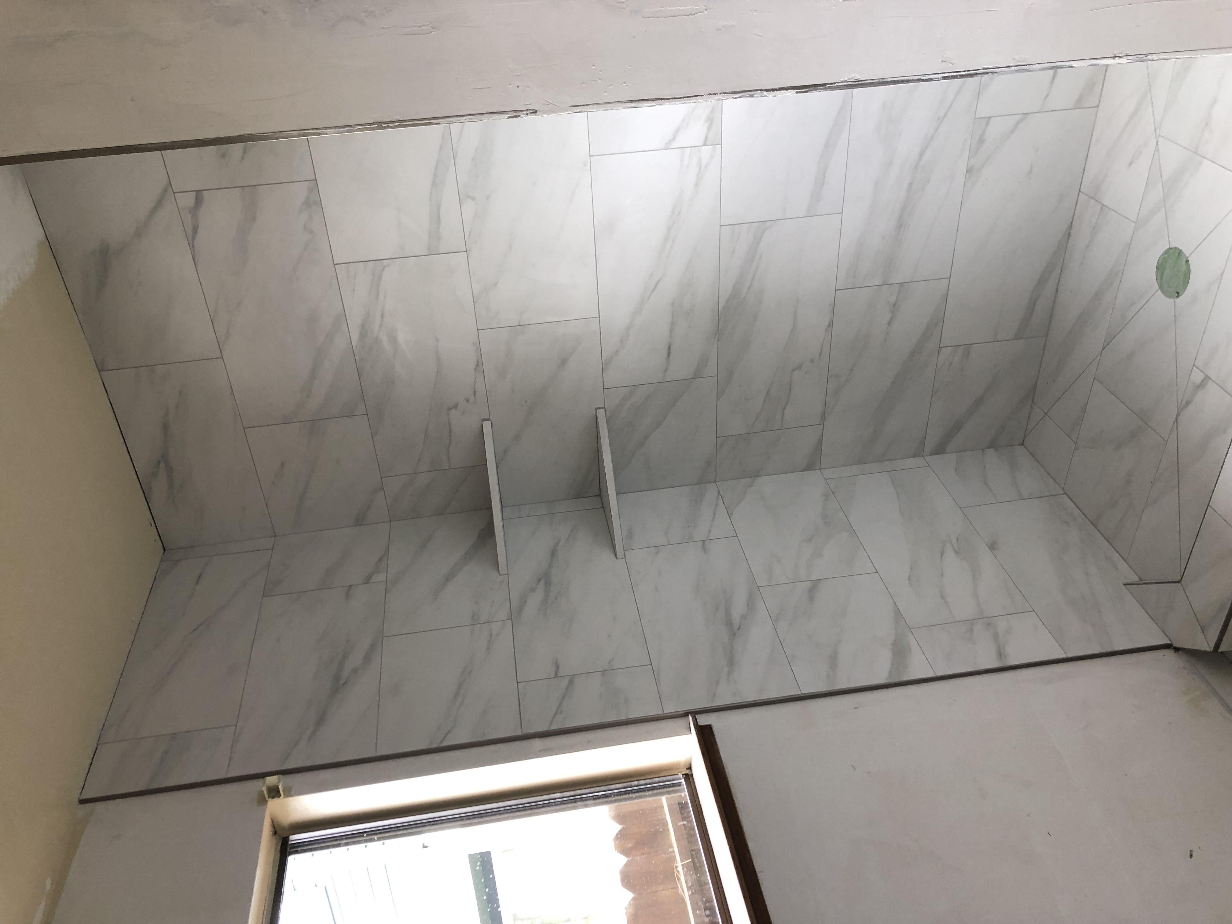 Wide view of marble walk-in shower