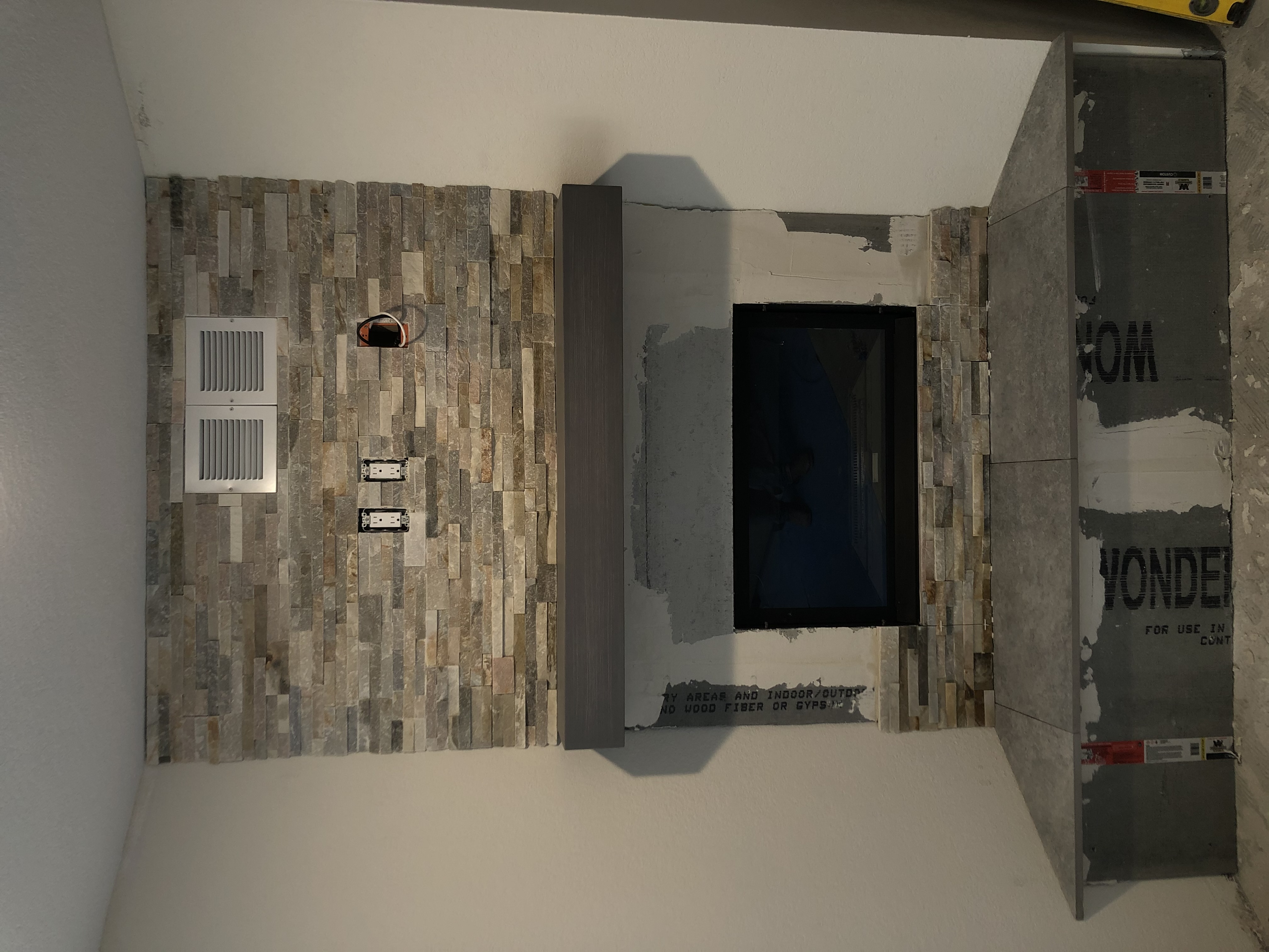 Stone fireplace installation in progress