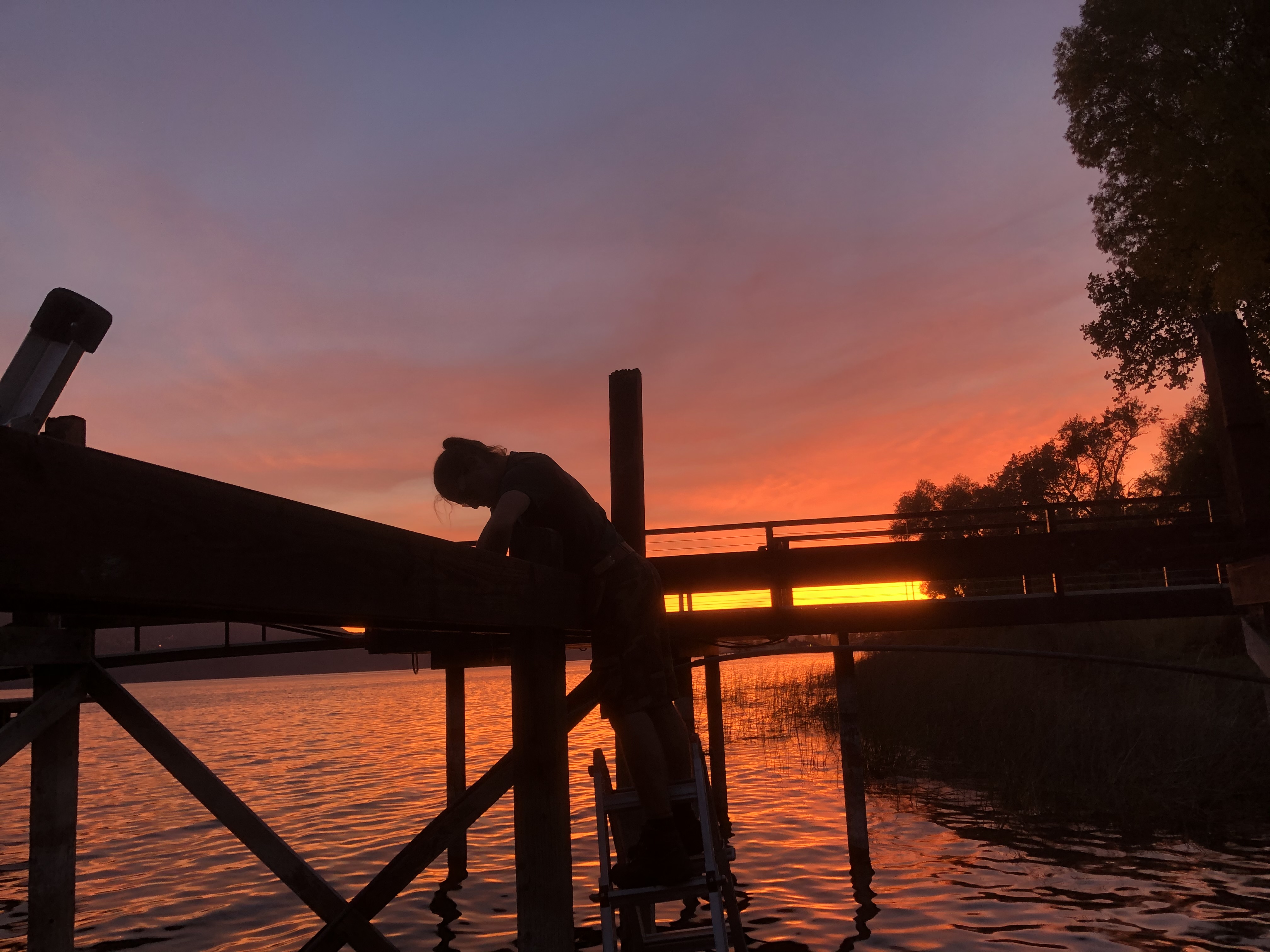 Dock construction at sunset on the lake