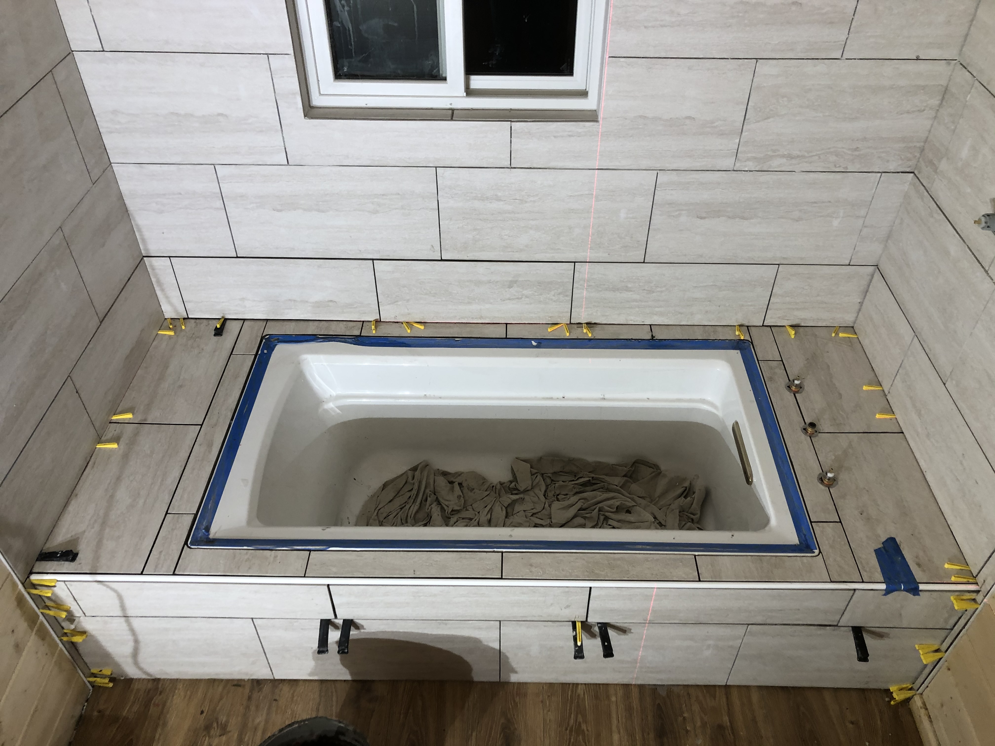 Bathtub surround with tile nearly complete